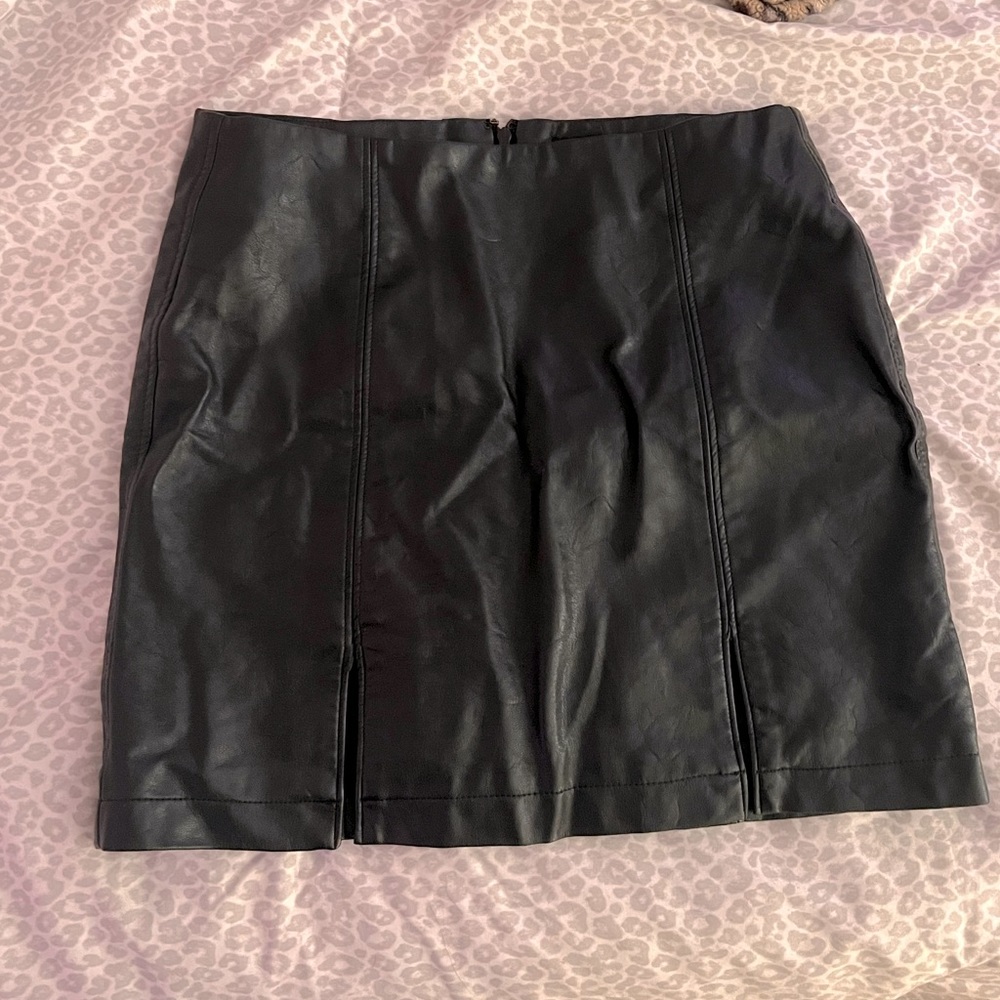 Black leather mini skirt. Size Medium, but runs small. Slits on the front